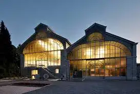 Illuminated facade of the Art Interpretation Centre of Vresse-sur-Semois at dusk